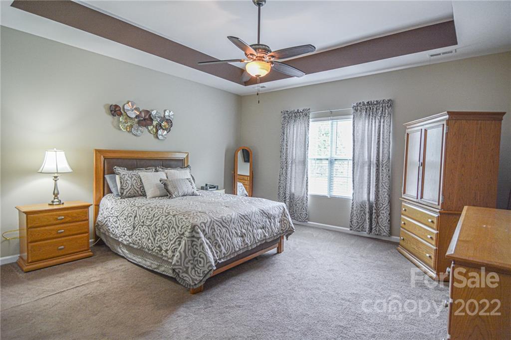 1672 Beleek Ridge Lane Clover, SC 29710 - Photo 11 of 32 a spacious bedroom with a bed a couch and a window