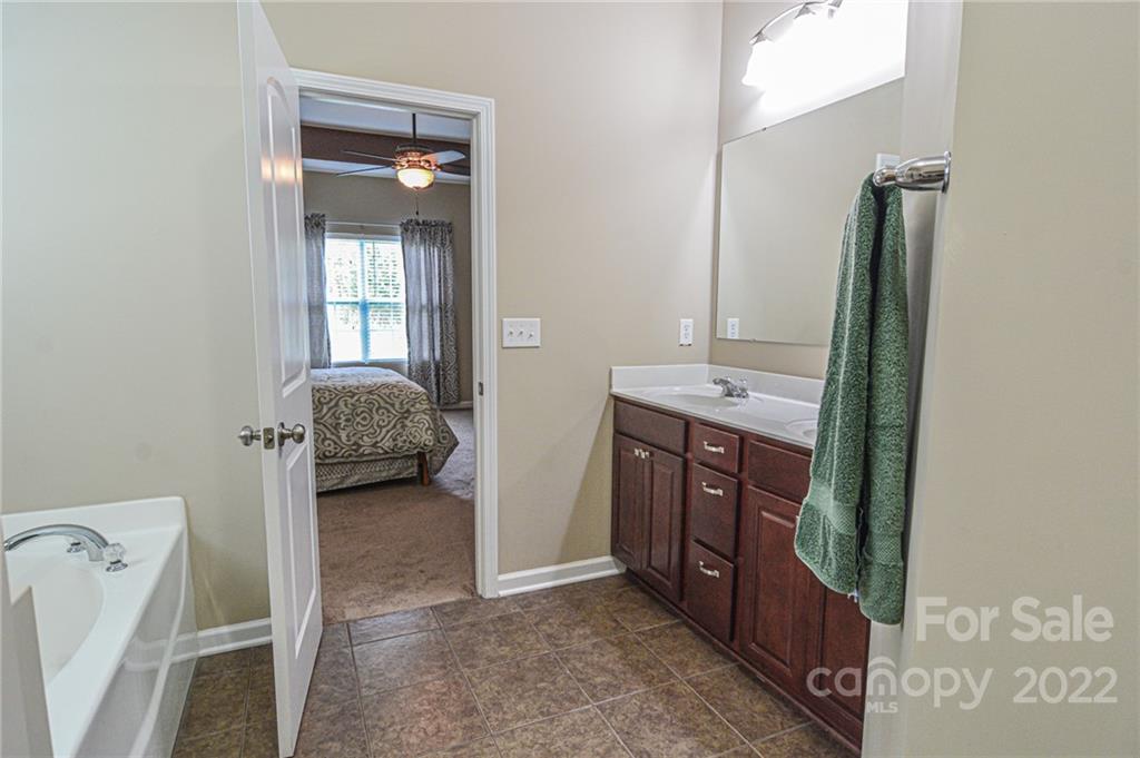 1672 Beleek Ridge Lane Clover, SC 29710 - Photo 14 of 32 a en suite bathroom with a sink a mirror and a bathtub