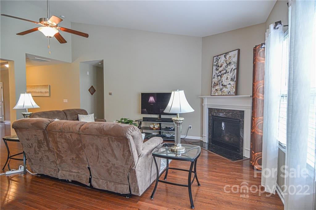 1672 Beleek Ridge Lane Clover, SC 29710 - Photo 6 of 32 a living room with furniture a fireplace and a flat screen tv