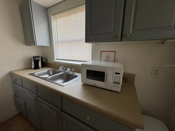 a kitchen with a sink cabinets and a stove