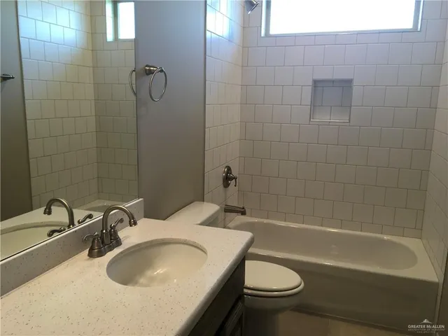 a bathroom with a sink a toilet and a bathtub