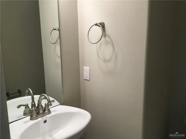 a bathroom with a sink and mirror