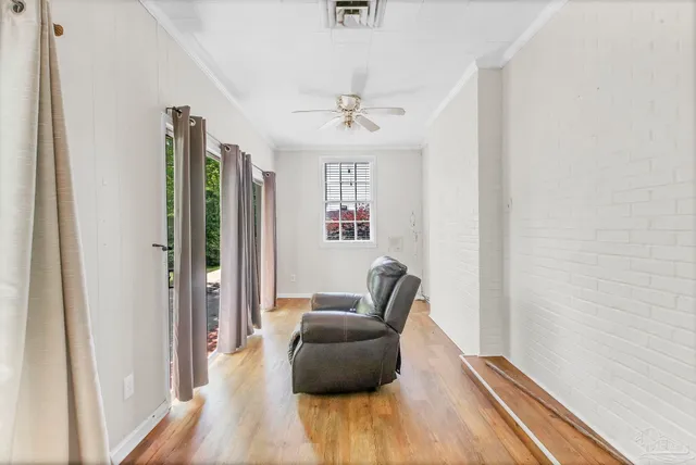 a view of a livingroom with wooden floor and a window