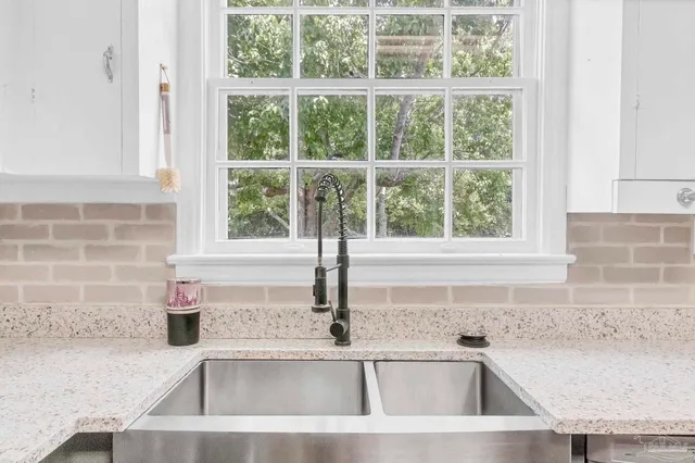 a kitchen with a refrigerator and wooden floor