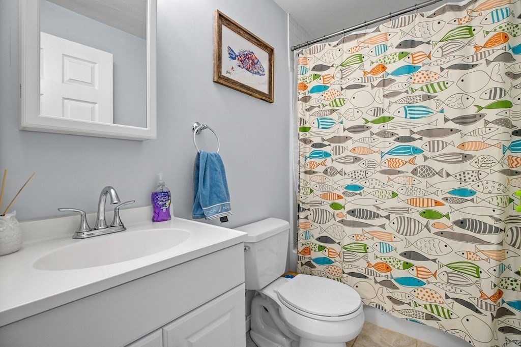 176 Stockbridge Road Scituate, MA 02066 - Photo 17 of 27 a bathroom with a sink toilet and a shower curtain