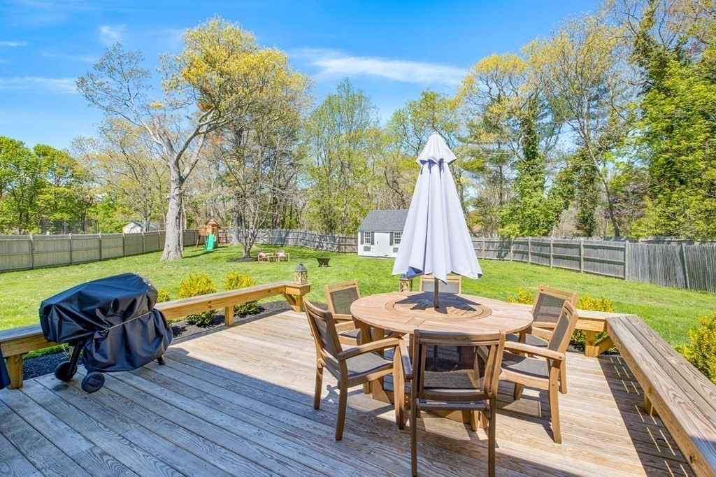 176 Stockbridge Road Scituate, MA 02066 - Photo 21 of 27 a view of a patio with a table chairs and a backyard