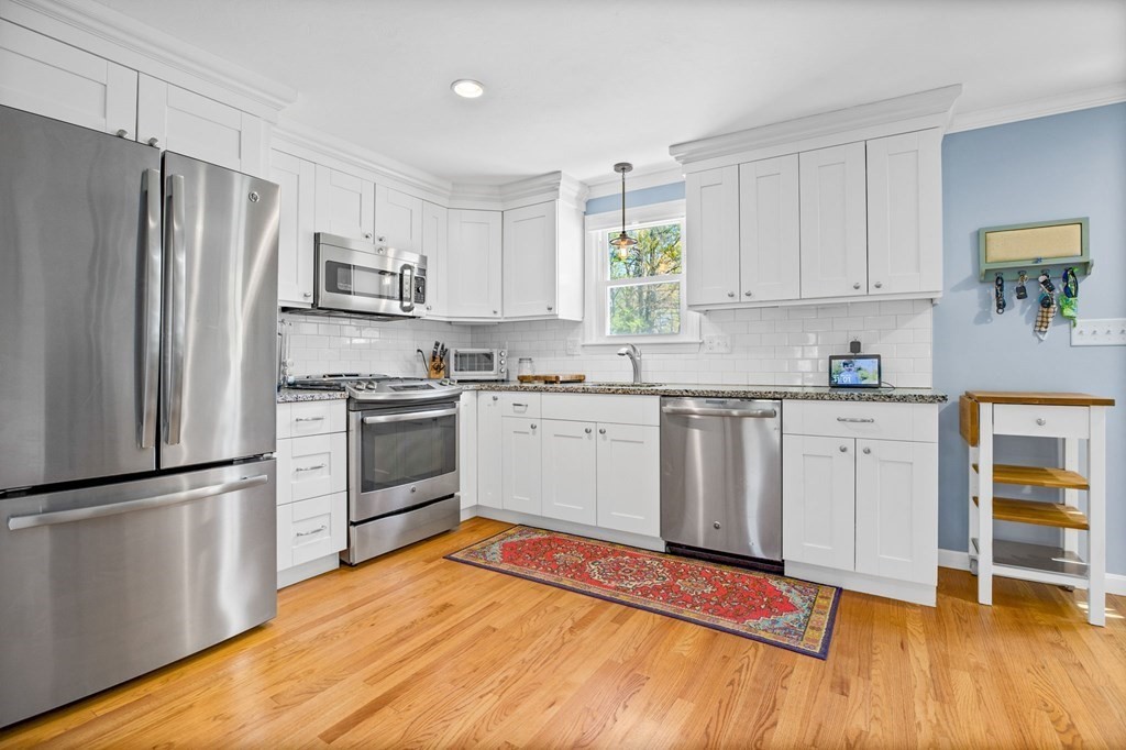 176 Stockbridge Road Scituate, MA 02066 - Photo 3 of 27 a kitchen with white cabinets stainless steel appliances and a window