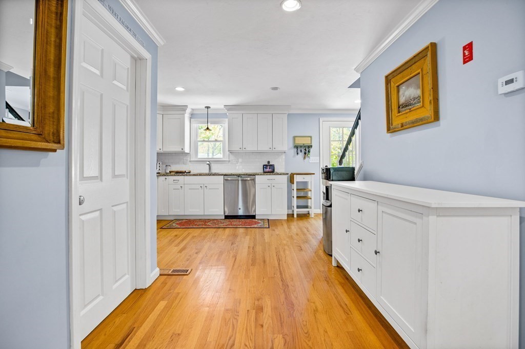 176 Stockbridge Road Scituate, MA 02066 - Photo 4 of 27 a large white kitchen with wooden floors