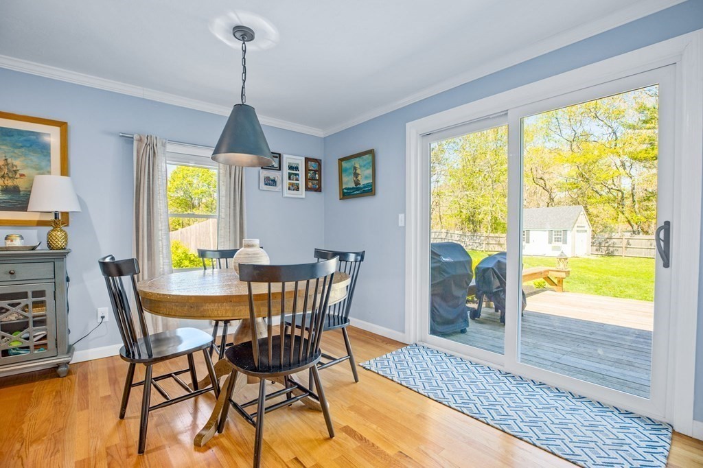 176 Stockbridge Road Scituate, MA 02066 - Photo 9 of 27 a dining room with furniture a chandelier and wooden floor