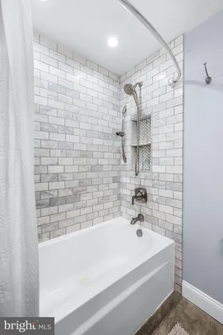 a bathroom with a bathtub and shower