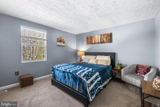 a bedroom with a bed and a couch