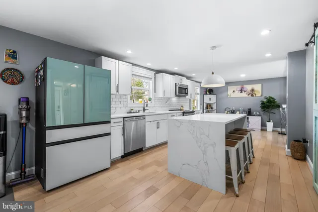 a kitchen with a sink stainless steel appliances and cabinets