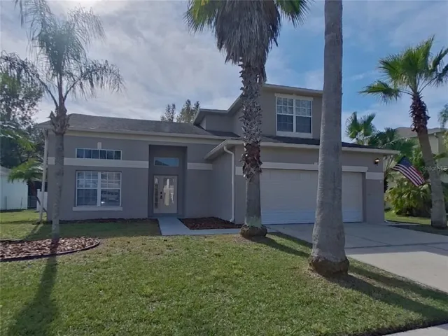 a front view of a house with a garden and yard
