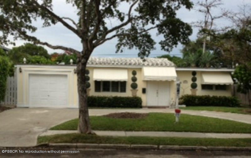 249 Alpine Road West Palm Beach, FL 33405 - Photo 1 of 16 a front view of a house with a yard and garage