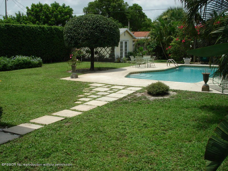 249 Alpine Road West Palm Beach, FL 33405 - Photo 2 of 16 a view of a swimming pool with a garden