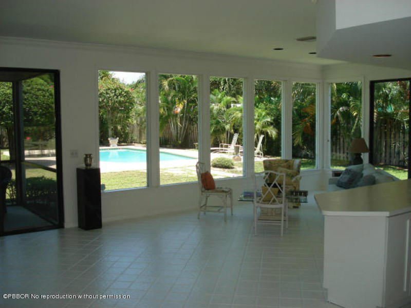 249 Alpine Road West Palm Beach, FL 33405 - Photo 8 of 16 a view of a dining room with furniture large windows and garden view