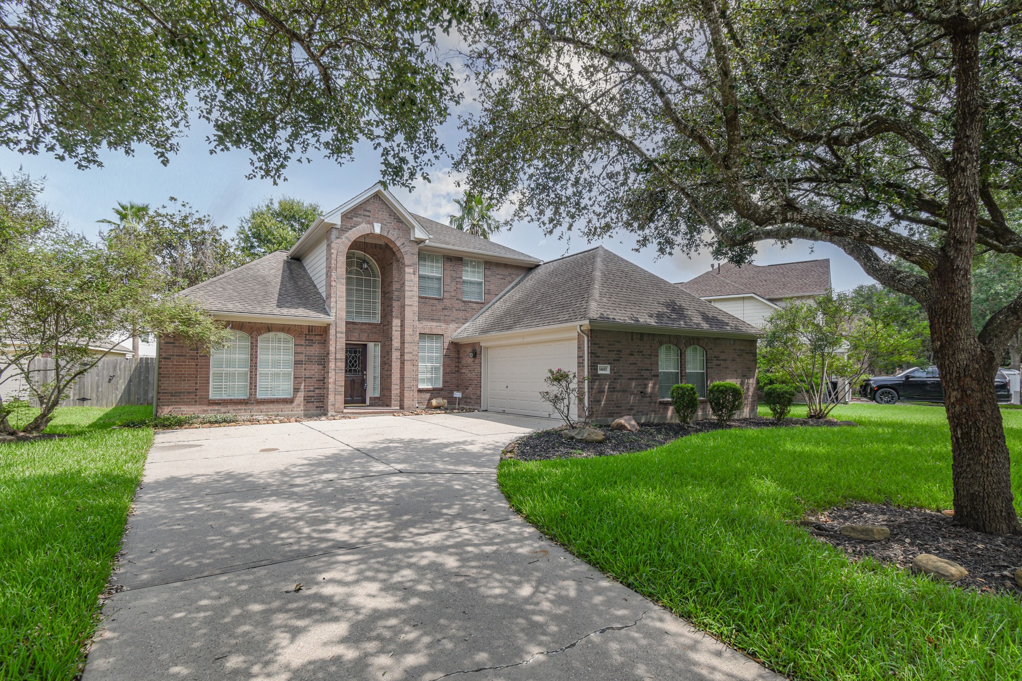 14603 Kings Head Drive Houston, TX 77044 - Photo 1 of 33 a front view of a house with a garden and trees