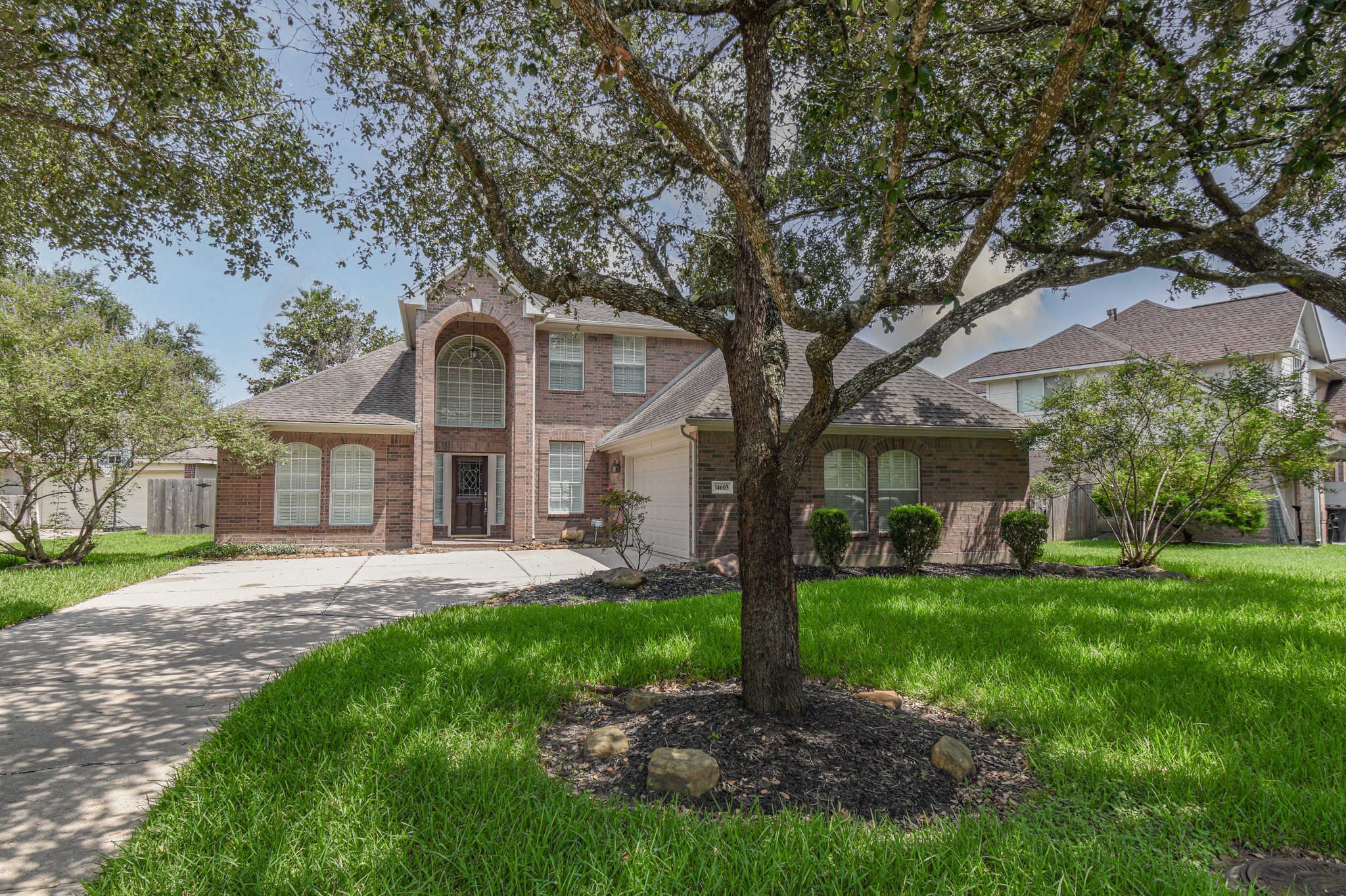 14603 Kings Head Drive Houston, TX 77044 - Photo 2 of 33 a front view of a house with a garden and trees