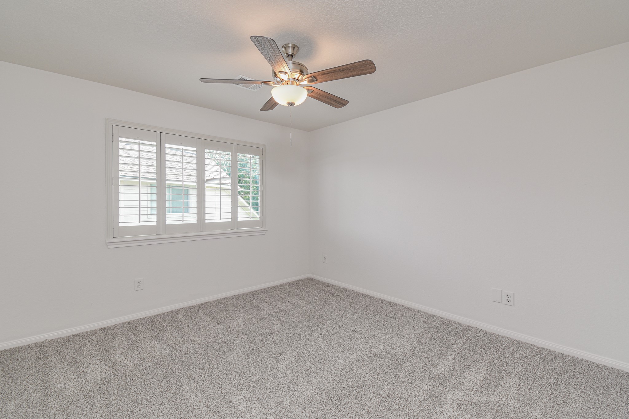 14603 Kings Head Drive Houston, TX 77044 - Photo 25 of 33 an empty room with windows and fan
