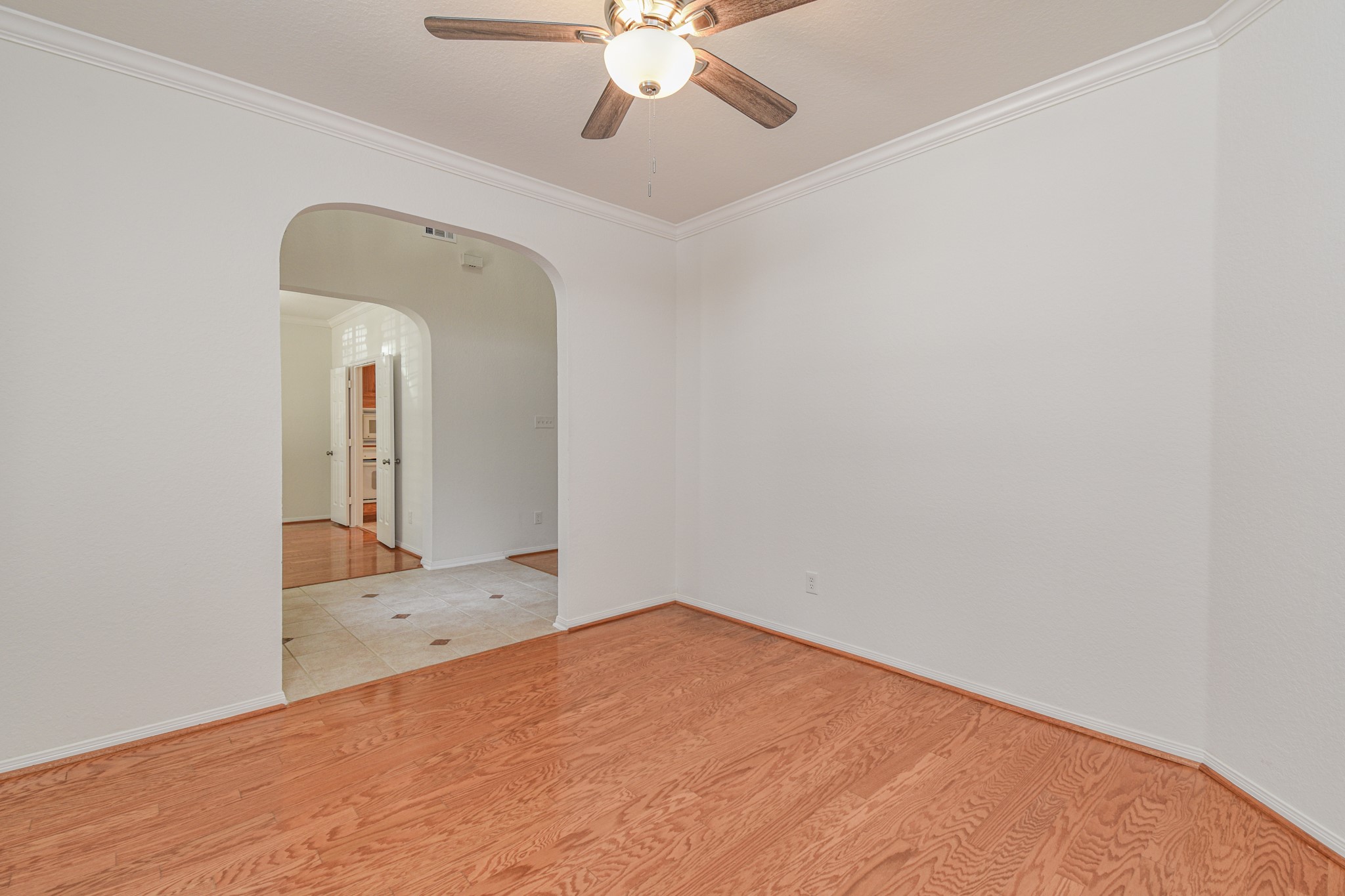 14603 Kings Head Drive Houston, TX 77044 - Photo 7 of 33 a view of a room with a chandelier fan and wooden floor