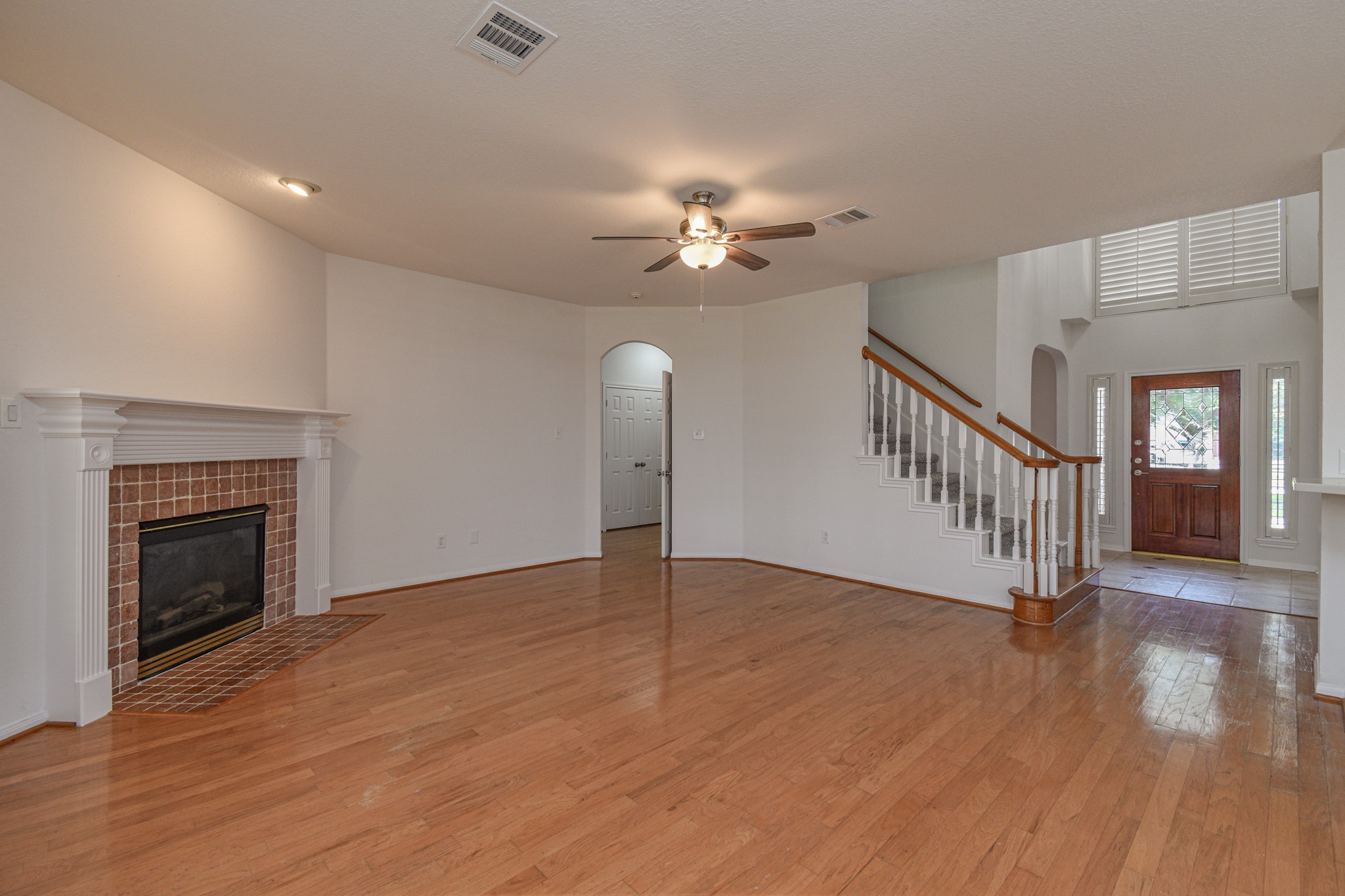 14603 Kings Head Drive Houston, TX 77044 - Photo 9 of 33 a view of an empty room with wooden floor fireplace and a window