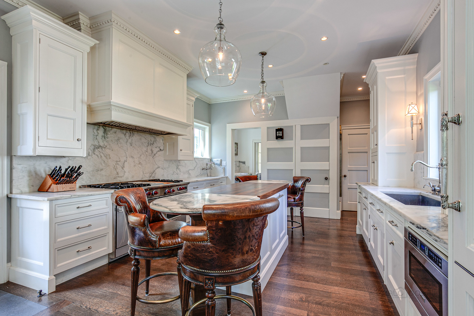 1220 Elm Tree Road Lake Forest, IL 60045 - Photo 16 of 55 a kitchen with stainless steel appliances kitchen island granite countertop a table chairs sink and cabinets