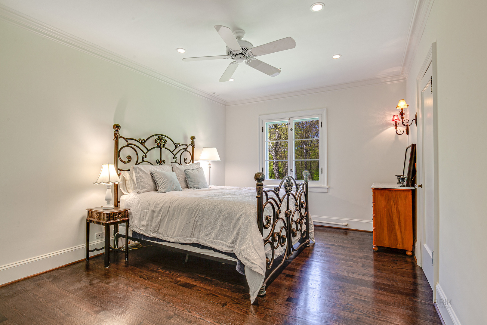 1220 Elm Tree Road Lake Forest, IL 60045 - Photo 38 of 55 a bedroom with a bed and a chandelier