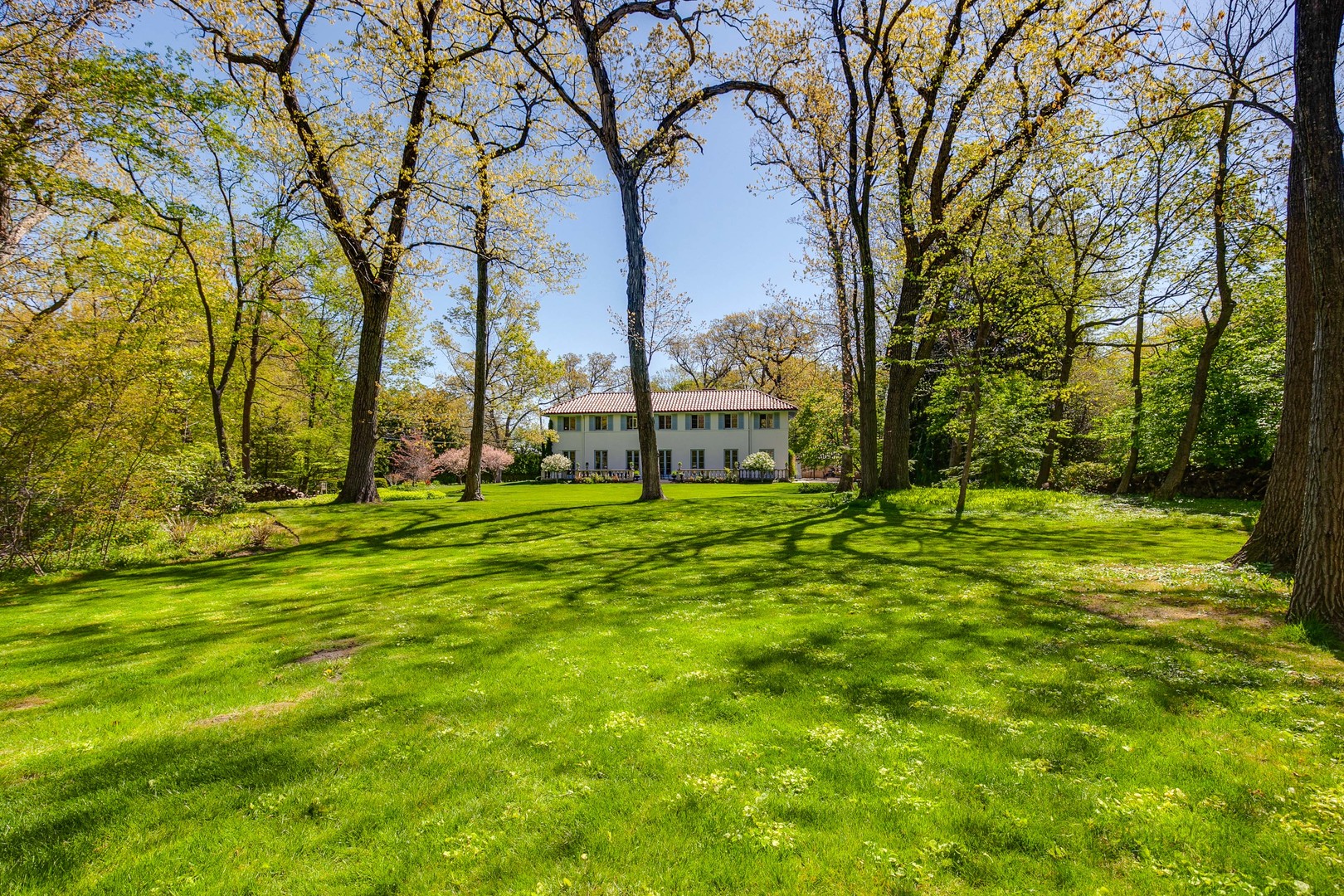 1220 Elm Tree Road Lake Forest, IL 60045 - Photo 46 of 55 a backyard of a house with lots of green space and fountain