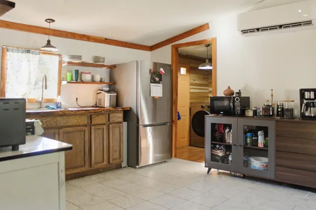 a kitchen with refrigerator and cabinets