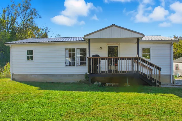 a front view of a house with yard and garage