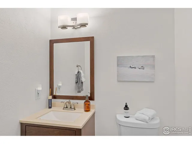 a bathroom with a sink mirror and vanity