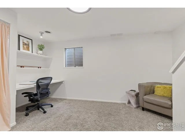 a living room with furniture and a ceiling fan