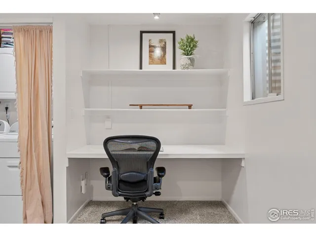 a bedroom with a bed and a wall painting