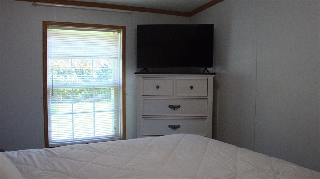 20 Deer Run Brookfield, MA 01506 - Photo 25 of 29 a bedroom with a flat screen tv on the dresser and a window