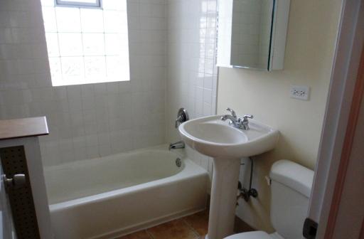 2450 West Addison Street, Unit 2B Chicago, IL 60618 - Photo 7 of 10 a white bath tub sitting next to a white sink