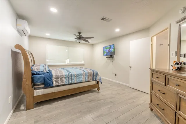 a bedroom with a bed and with furniture