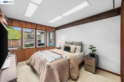 a bedroom with a large bed and a large window