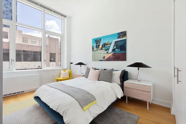a bedroom with bed and a window