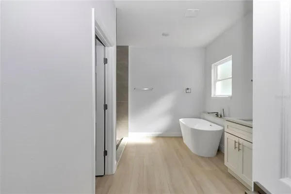 a spacious bathroom with a bathtub and shower