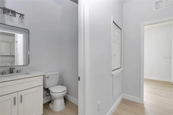 a bathroom with a toilet sink and a mirror