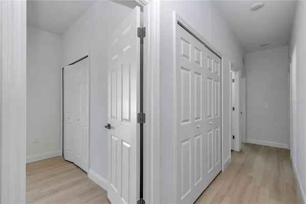 a view of a hallway with wooden floor