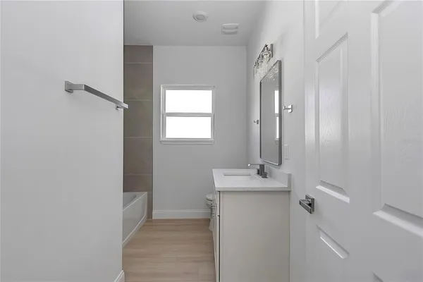 a bathroom with a sink a mirror and a window