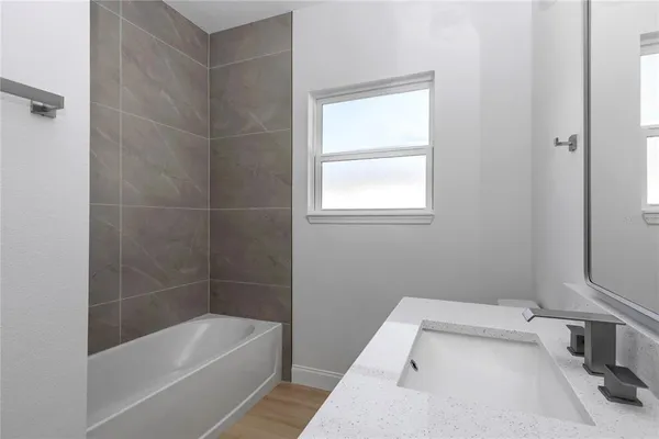 a bathroom with a bathtub and window