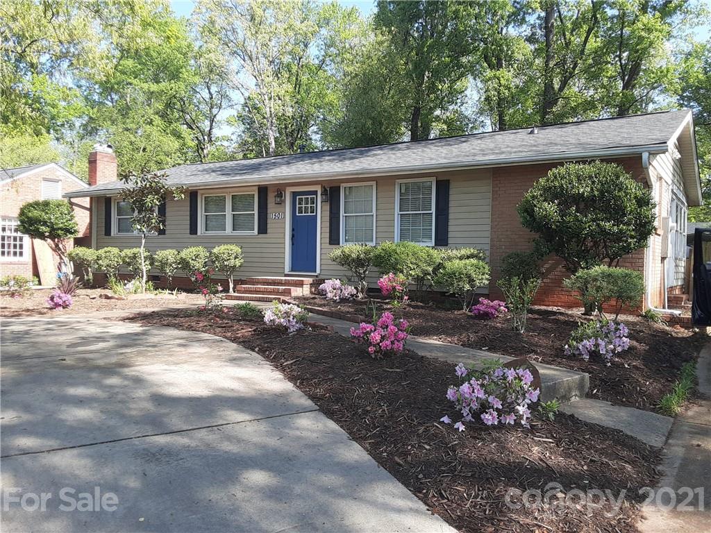 1501 Tyvola Road Charlotte, NC 28210 - Photo 1 of 20 a front view of a house with a yard and a garden