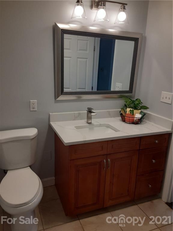 1501 Tyvola Road Charlotte, NC 28210 - Photo 11 of 20 a bathroom with a sink and a toilet