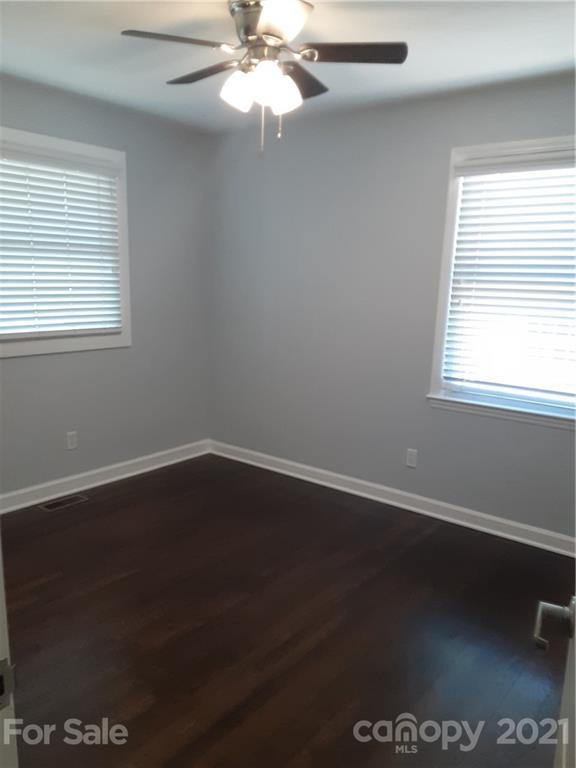 1501 Tyvola Road Charlotte, NC 28210 - Photo 15 of 20 a view of an empty room with wooden floor and a window