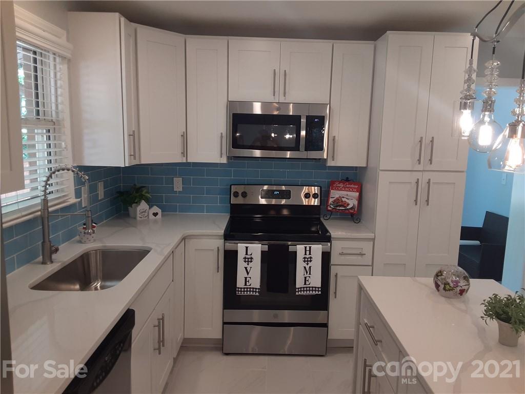 1501 Tyvola Road Charlotte, NC 28210 - Photo 3 of 20 a kitchen with a stove and a sink