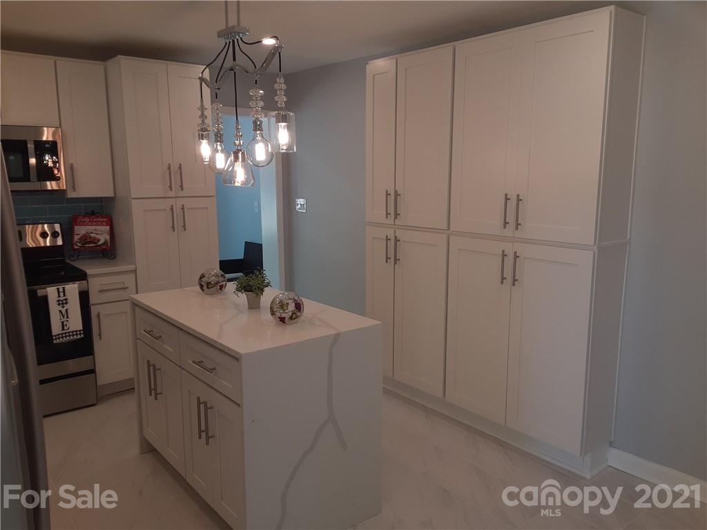 1501 Tyvola Road Charlotte, NC 28210 - Photo 4 of 20 a bathroom with a sink vanity and shower