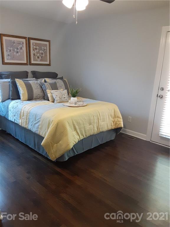 1501 Tyvola Road Charlotte, NC 28210 - Photo 7 of 20 a bedroom with a bed and wooden floor