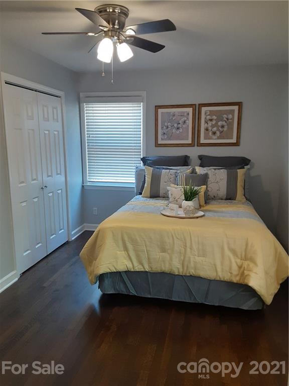 1501 Tyvola Road Charlotte, NC 28210 - Photo 8 of 20 a bedroom with a bed and a lamp on dresser